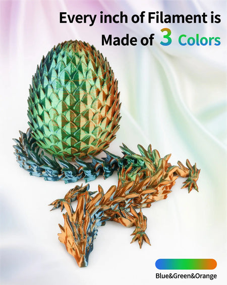 Close-up of a 3D printed dragon and egg showcasing the continuous color shift of LANDU Tri-Color Blue Green Orange Silk PLA filament.